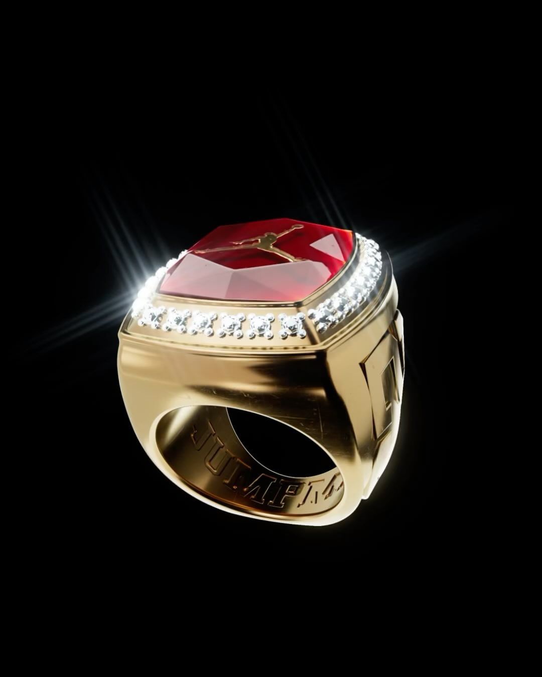 A golden championship ring with a red gem and diamond accents isolated against a black background, showcasing luxury jewelry.