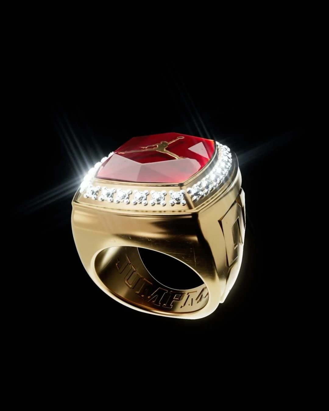 Close-up product shot of a gold championship ring featuring a large square red gem with a jumping figure silhouette and diamond pave band.