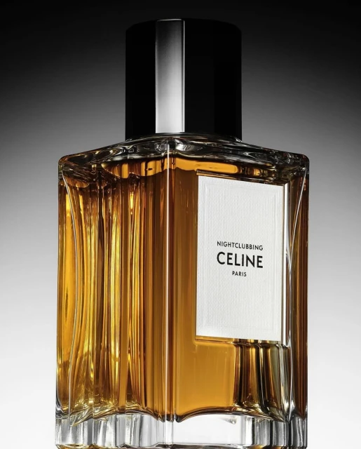 Elegant close-up of Celine 'Nightclubbing' perfume bottle featuring a square silhouette, faceted glass, and a dark cap against a gradient backdrop.