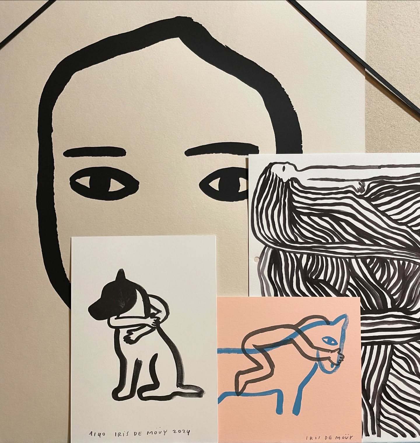 Illustration featuring a large face with black outlined eyes, hair, and eyebrows alongside drawings of animals in black outlines.