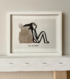 Framed ink illustration by Iris De Mouy of a stylized figure leaning against stone blocks