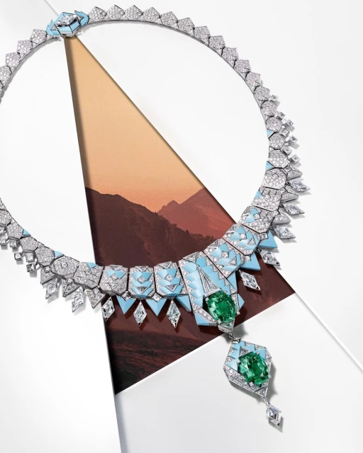 Elegant geometric diamond and gemstone necklace on a white surface with a landscape background, showcasing luxury jewelry design.