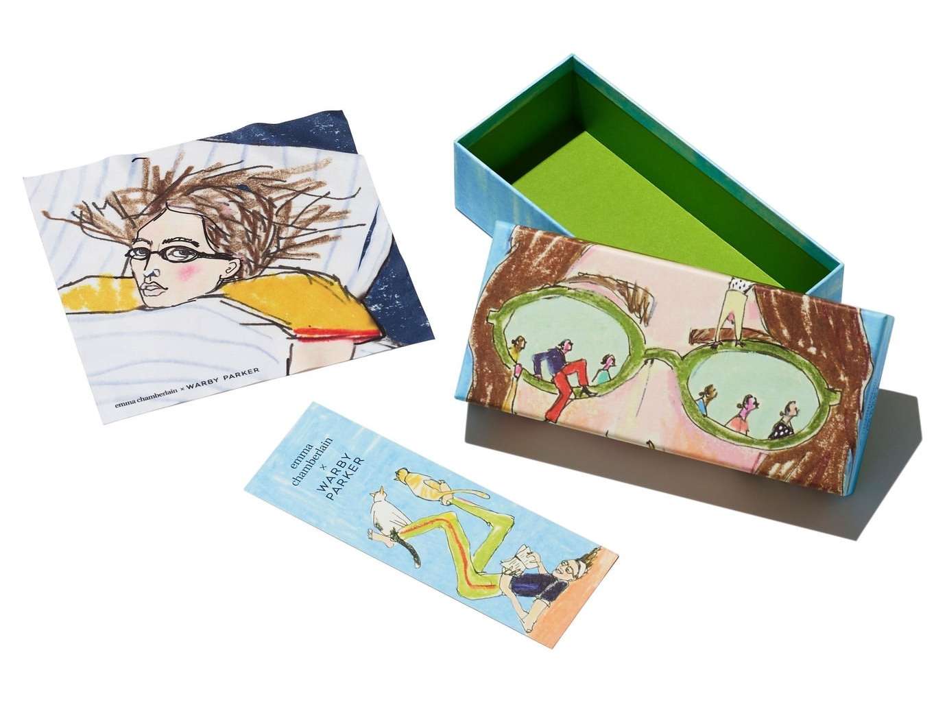 Whimsical product still life showcases eyeglasses box with an illustrated woman wearing glasses along with a bookmark and card.