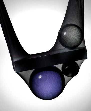Abstract image with a black bar and three spheres suspended in dark sheer hosiery against a gradient white background.