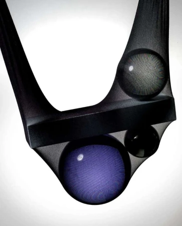 Abstract studio image of geometric shapes including a rectangle and spheres, held in place with sheer black fabric against a white background.