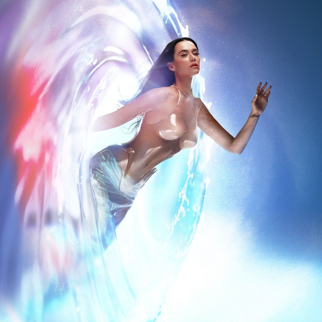 An adult woman with long, dark hair is the main subject of this artful image, surrounded by swirling water against a light blue backdrop.