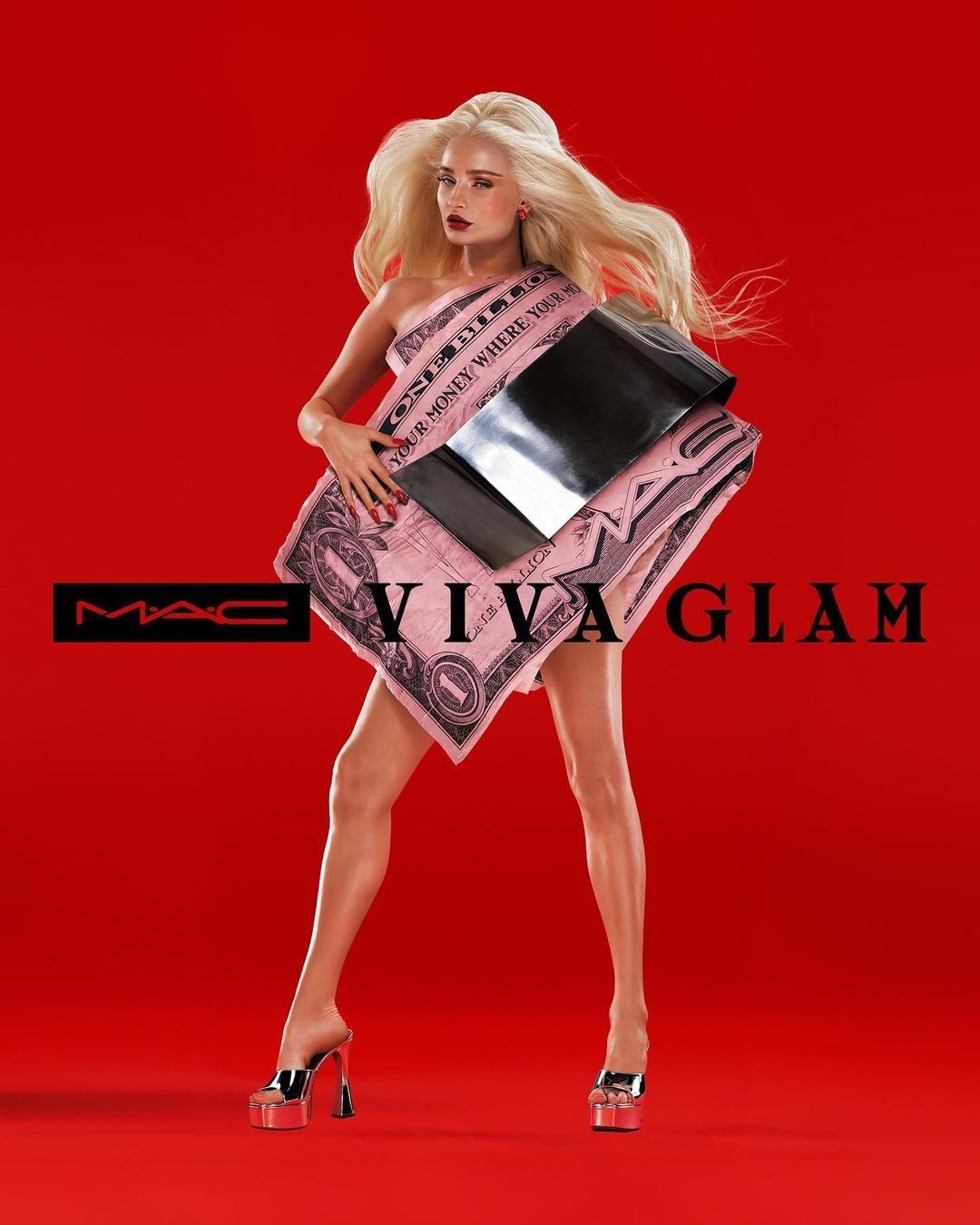 Blonde fashion model in a pink one-dollar bill dress and platform heels posing against a vibrant red background for a MAC Viva Glam advertisement.