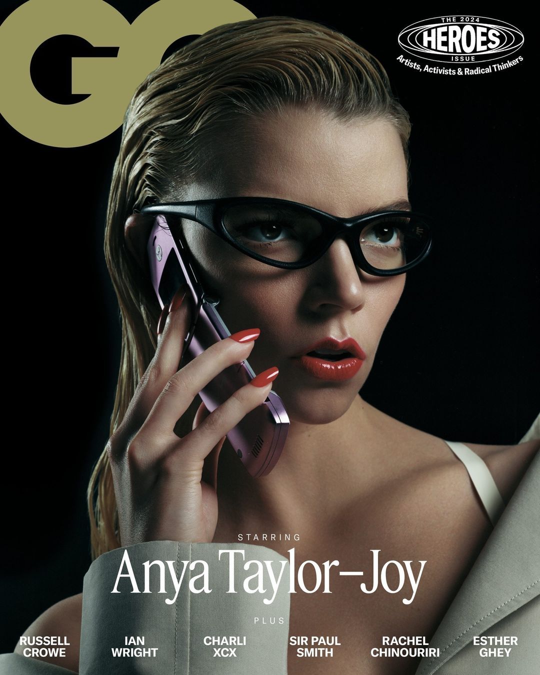 Magazine cover featuring Anya Taylor-Joy wearing glasses and holding a cell phone, against a dark background with GQ logo.