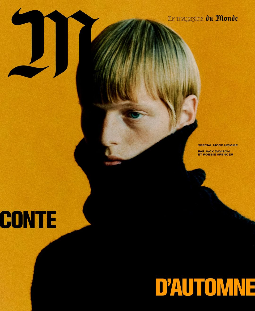 Magazine cover featuring a fair-skinned male model with blonde hair wearing a black turtleneck against a yellow background.