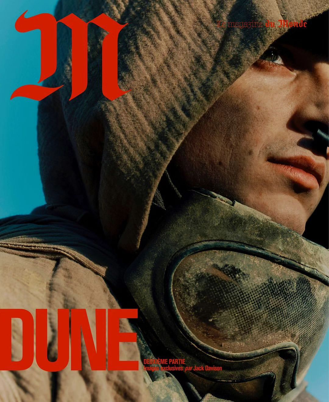 Magazine cover featuring a hooded person with a breathing mask and eyewear in an arid environment under a clear sky. Bold red text overlays the image.