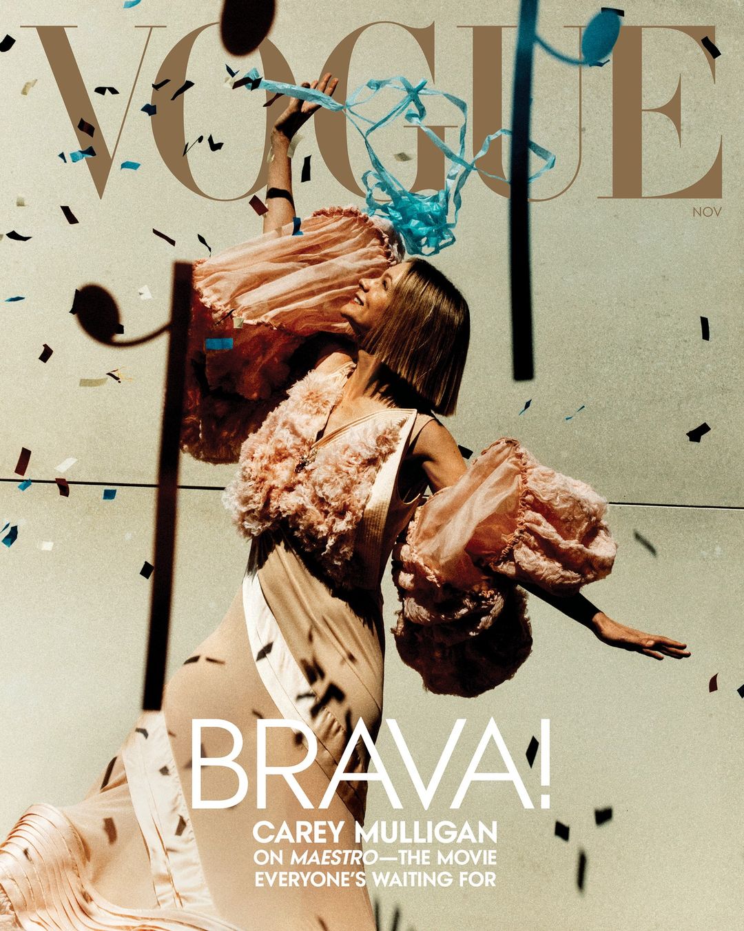 Magazine cover featuring Carey Mulligan in a peach-colored dress with confetti and streamers, emphasizing fashion and celebrity.