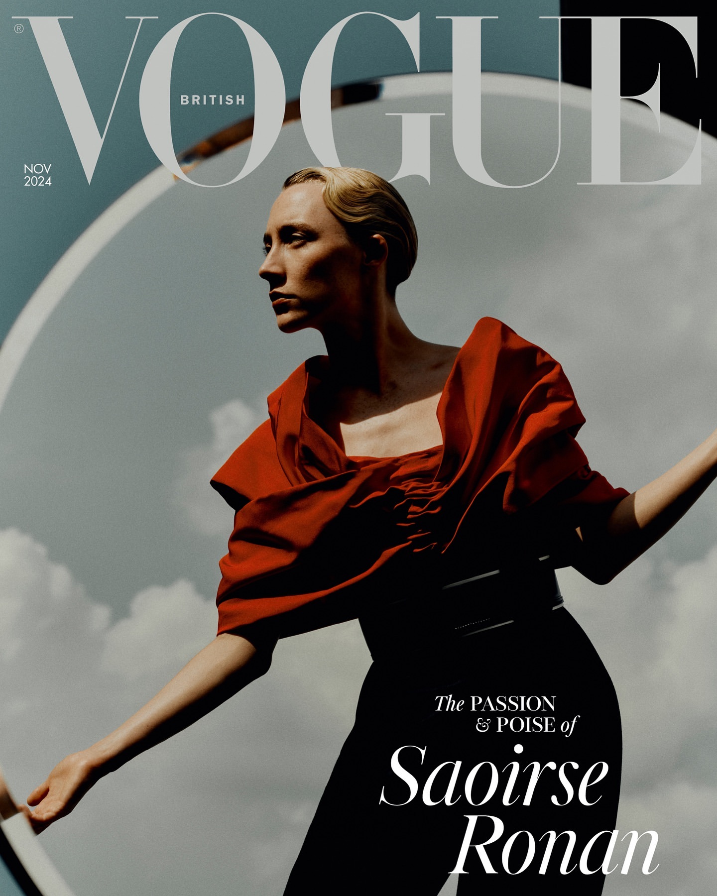 British Vogue cover featuring model Saoirse Ronan in red top and black pants, with Vogue masthead, set against cloudy sky and prop.