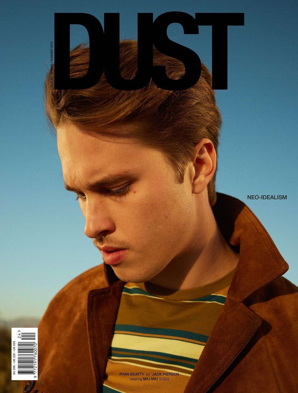 Magazine cover featuring a close-up of a young adult male with brown hair wearing a striped shirt and suede jacket against a blue sky.