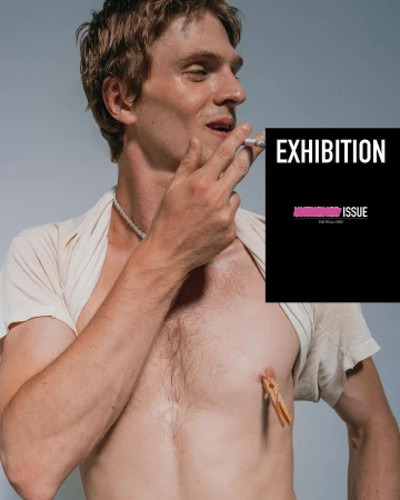 A shirtless adult man poses indoors with a cigarette and a clothespin attached to his chest with a black magazine cover overlay.