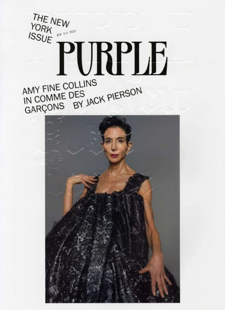 Magazine cover featuring Amy Fine Collins wearing a black dress, photographed in a photo studio with a grey background, with masthead.