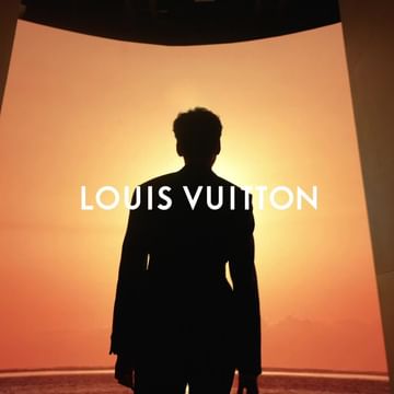 Silhouette of a person standing in front of a sunset with a blurred horizon, along with the Louis Vuitton logo.