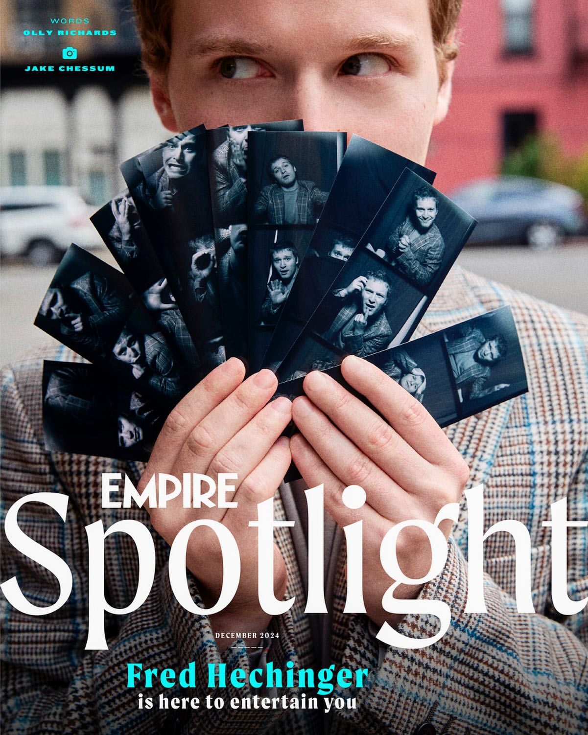 Young man in tweed blazer holds black and white portrait strips in an outdoor urban setting, with an Empire Spotlight magazine cover visible.