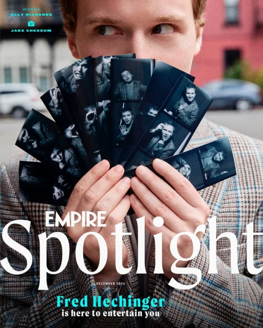 Young man in tweed blazer holds black and white portrait strips in an outdoor urban setting, with an Empire Spotlight magazine cover visible.
