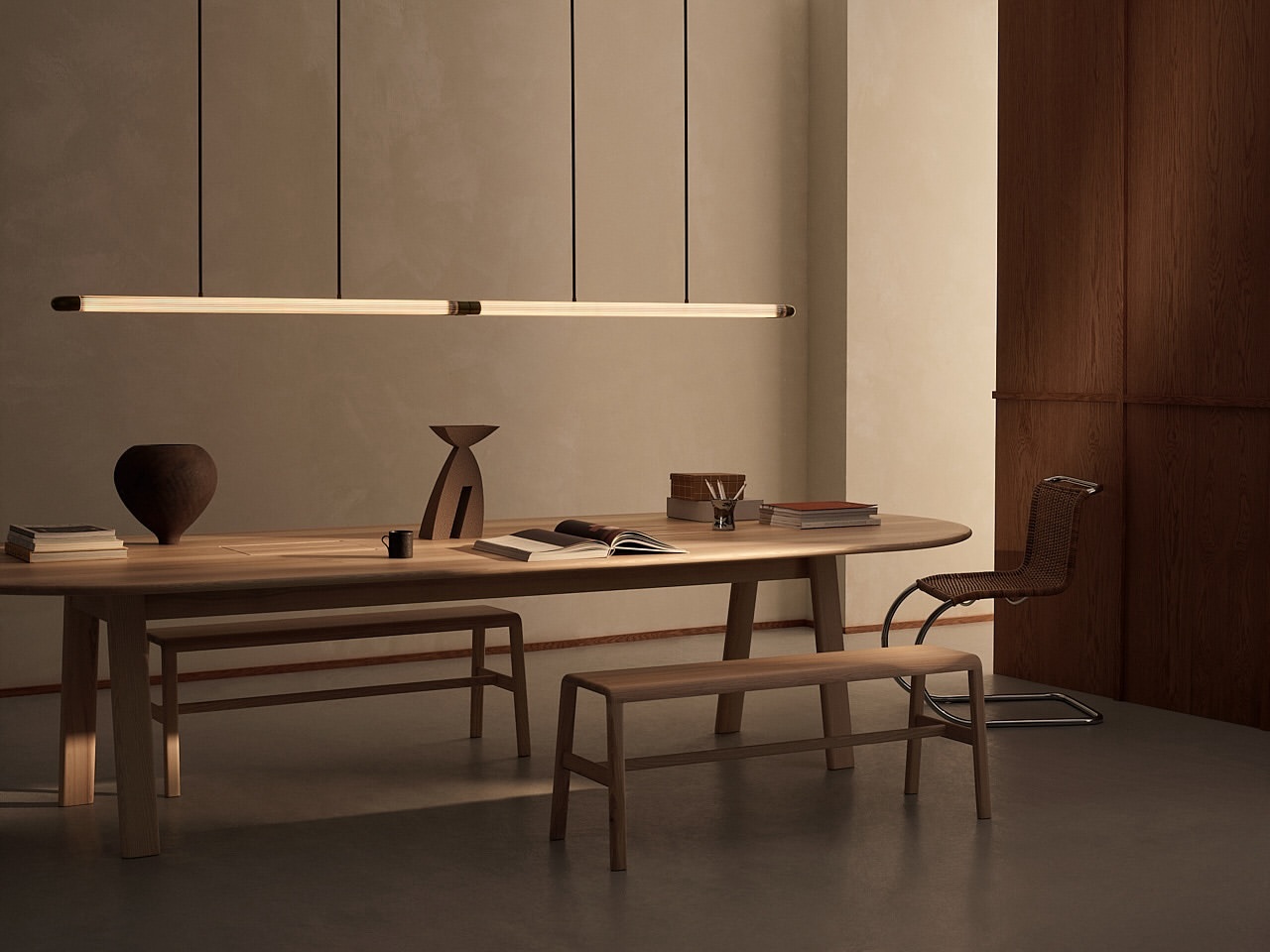 Modern dining room interior featuring a wooden table, chairs, pendant lights, and decorative objects in a minimalist setting.
