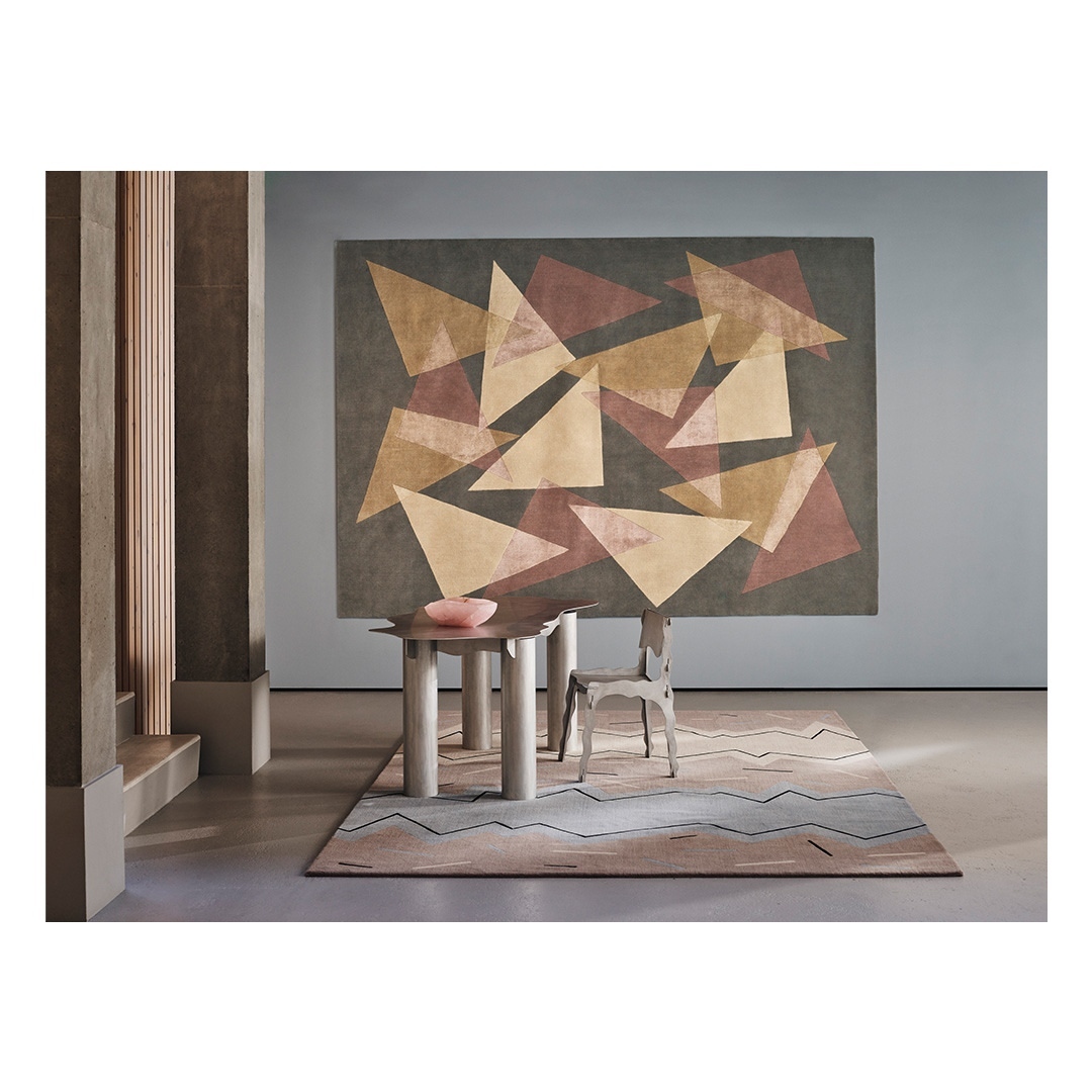 Interior design scene featuring modern table with pink bowl, geometric rug and carpet with geometric art in neutral colors.