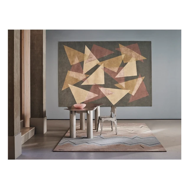 Interior design scene featuring modern table with pink bowl, geometric rug and carpet with geometric art in neutral colors.