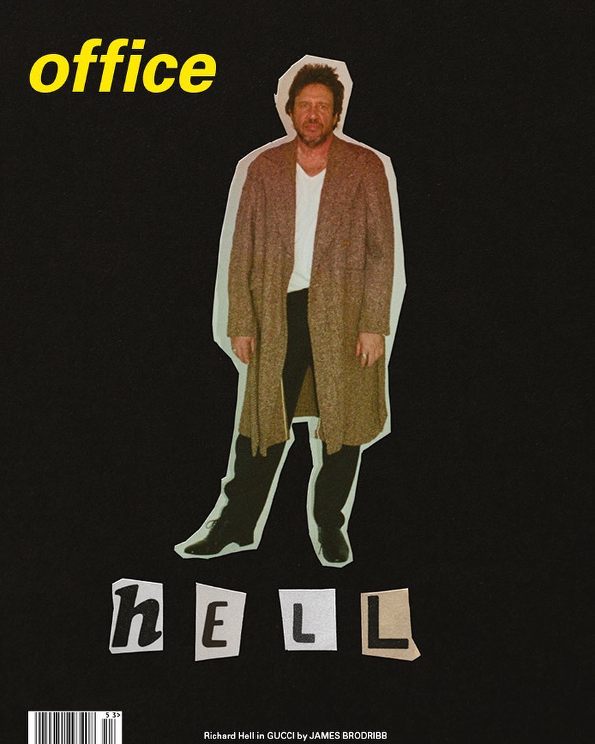 Magazine cover featuring a person in a long coat and the words 'office' and 'hell' against a black background in a studio setting.