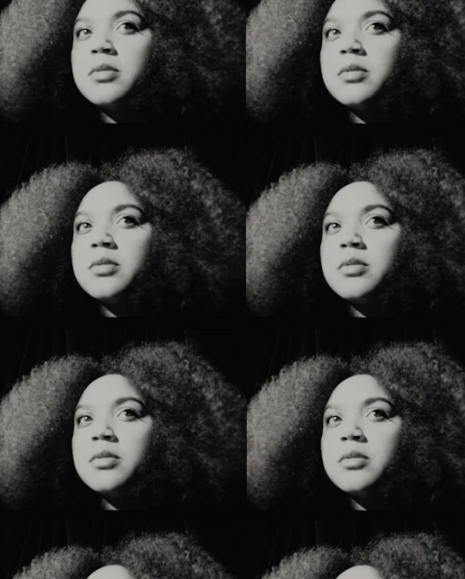 Monochrome portrait of a Black woman with afro in repeating pattern, creating a visually striking and artistic textured effect.