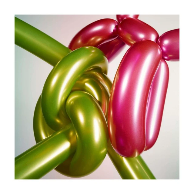 Close-up of green and pink intertwined, shiny balloon art forming abstract shapes with soft lighting and a clean, minimalist background.