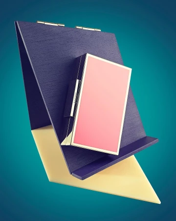 Elevated view of an open book with a pink book resting on the side, showcasing its cover, binding, and the angle created by the support.