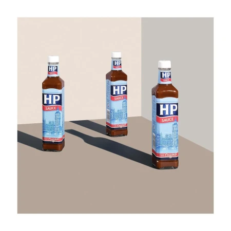 Three bottles of HP Sauce are arranged on a beige surface, casting dark shadows in a well-lit, minimalist studio setup. Food photography.