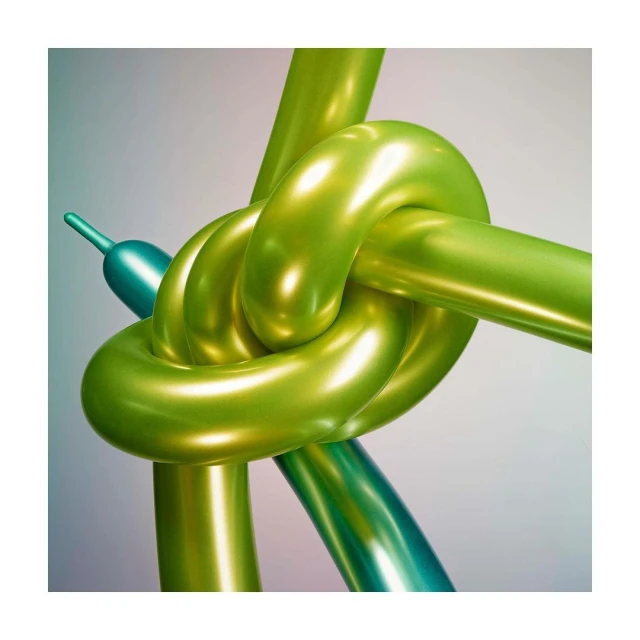 Close-up of two glossy, twisted balloon animals: one bright green, the other teal, set against a muted gray backdrop.