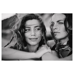Black and white close up portrait of two women outdoors with hair blowing in the wind by photographer James Meakin in Cape Town.