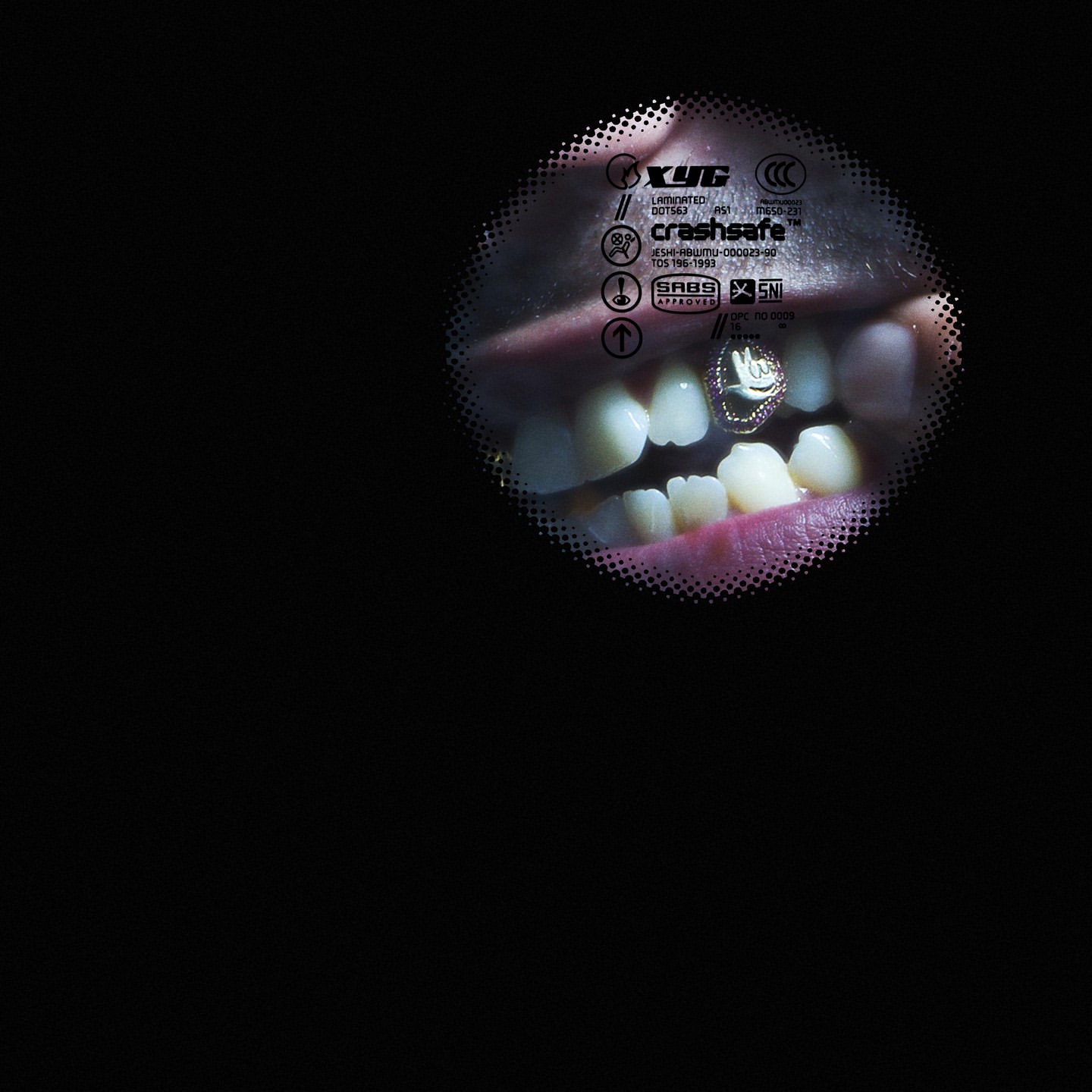 Close-up of teeth and lips with a metal grill in a black background. Focus on dental aesthetics and mouth jewelry.