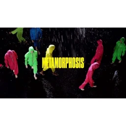 Group of barefoot people in colorful hooded jumpsuits walking in the rain with bold yellow METAMORPHOSIS text.