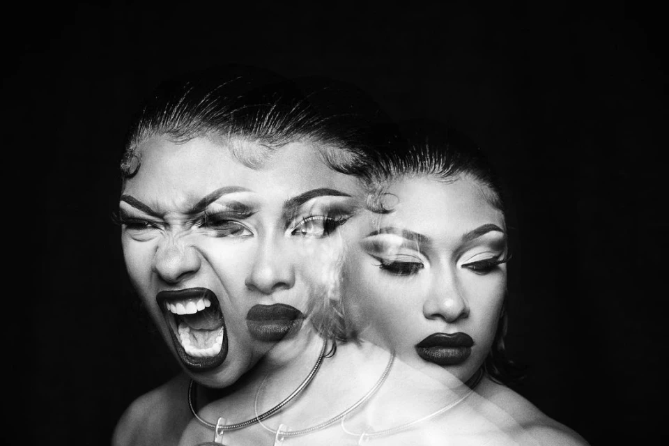 Black and white studio portrait of an African-American woman with dynamic expressions, showcasing striking makeup and a bold, artistic vision.