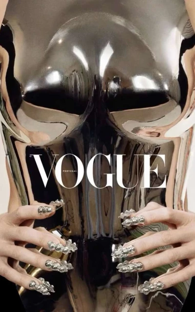 Fashion magazine cover featuring a silver metallic body form, hands with silver nail accessories, and the 'Vogue' magazine logo.