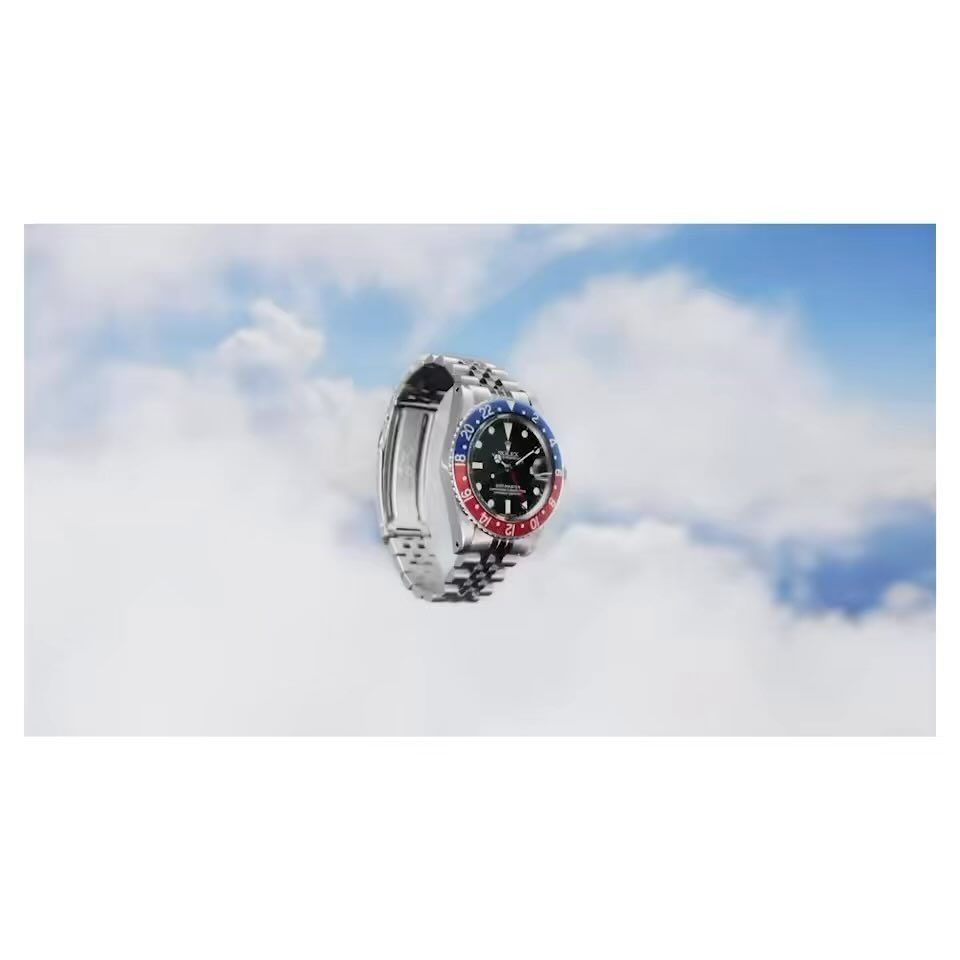 Elevated view of a silver wristwatch against a backdrop of clouds, evoking a sense of luxury and soaring style.
