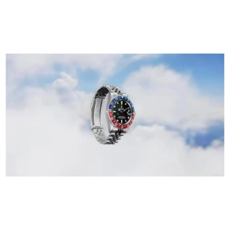 Elevated view of a silver wristwatch against a backdrop of clouds, evoking a sense of luxury and soaring style.