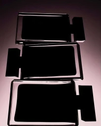 Three dark perfume bottles stacked vertically against a soft gradient background captured by Jarren Vink