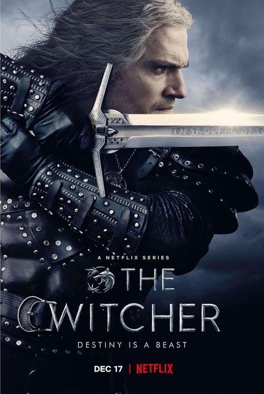 Poster of The Witcher on Netflix featuring Geralt with his sword. A male with long white hair is in black studded leather armor.