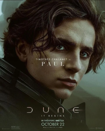 Close-up of Timothée Chalamet as Paul in the Dune movie poster, with dark hair, serious expression, and visible movie branding and release date.