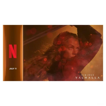 Adult woman with sword in Viking costume with blond hair. Netflix advertisement for Vikings Valhalla, set in muted yellow, red tones.