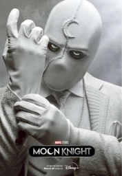 Close-up portrait of Moon Knight in a white suit and mask pulling on white leather gloves, photographed by Jason Bell.