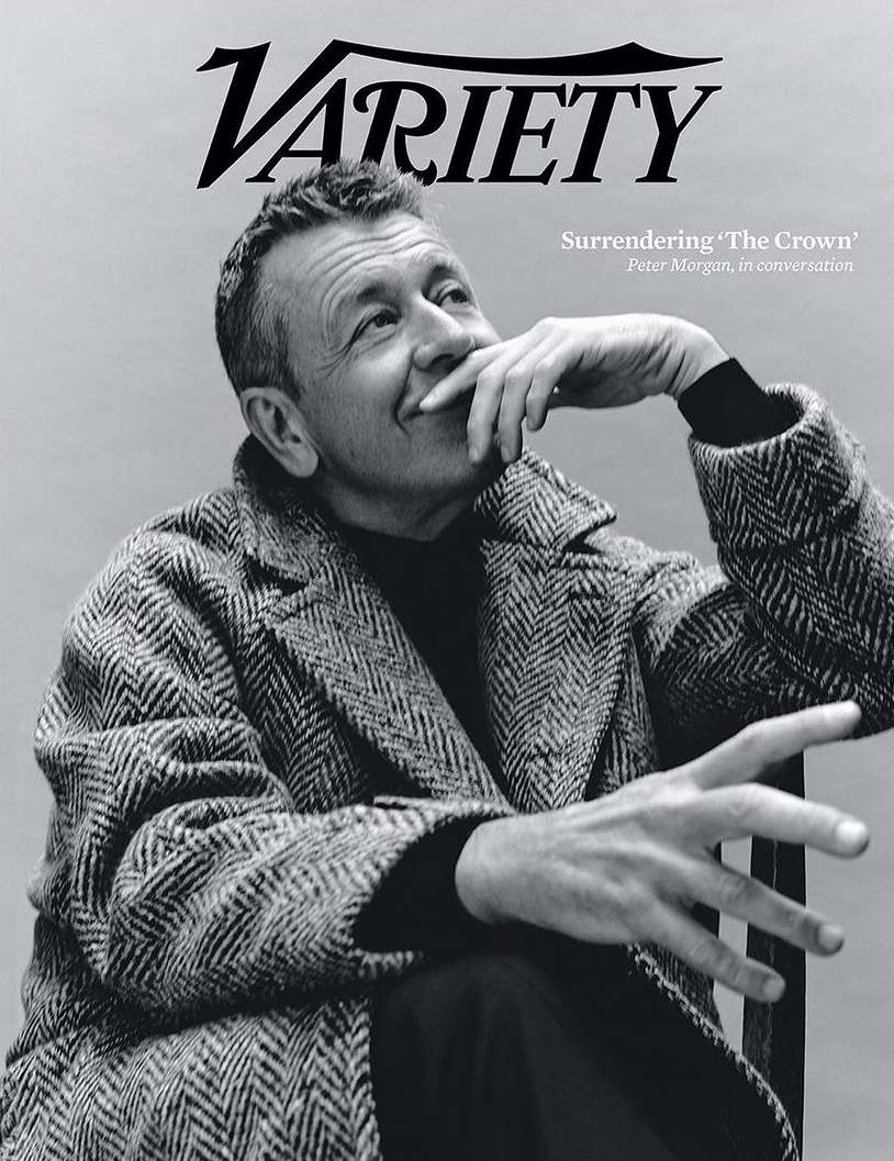 Black and white portrait of Peter Morgan on the cover of Variety, wearing a herringbone coat, resting his chin on his hand.