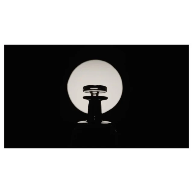 Elegant decanter silhouetted against a bright circle, creating a modern and minimalist glassware product shot for lifestyle promotion.