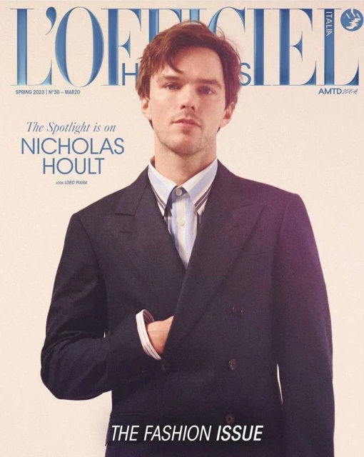 Magazine cover featuring Nicholas Hoult in a double-breasted navy suit, promoting 'The Fashion Issue' for L'Officiel Italia, Spring 2023.