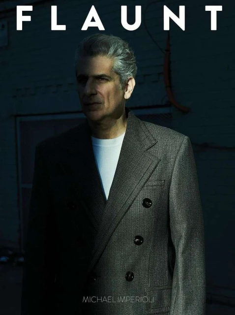 Portrait of actor Michael Imperioli on the cover of Flaunt magazine, wearing a grey suit against a muted, dark-toned background.