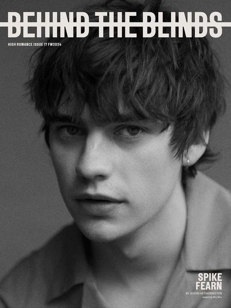 Black and white portrait of Spike Fearn on the cover of Behind the Blinds, High Romance Issue 17 / FW2324, looking directly at the camera.