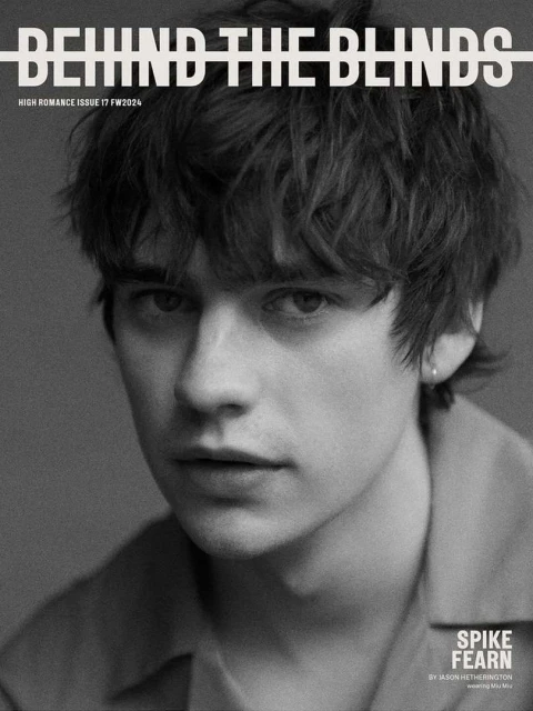 Black and white portrait of Spike Fearn on the cover of Behind the Blinds, High Romance Issue 17 / FW2324, looking directly at the camera.