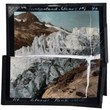 Old, colorized slide film of Switzerland's Rhone Glacier featuring a close view of its detailed icy formations and mountainous landscape.